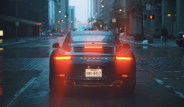 A porche or expensive car on a rainy day, signifying the evolving landscape of auto loan industry